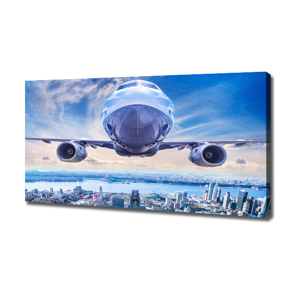 Fotocuadro en lienzo de alta calidad horizontal Un avión sobre la ciudad