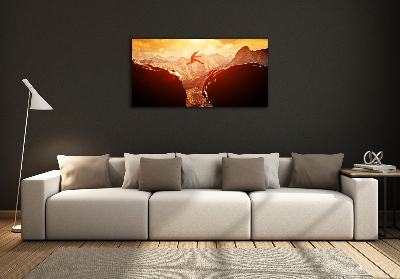 Cuadro decorativo de vidrio para salón horizontal Saltar sobre el abismo