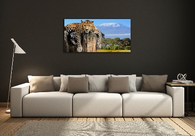 Cuadro decorativo de vidrio para salón horizontal Leopardo en un tocón de árbol