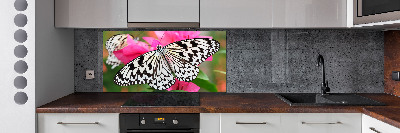 Panel antisalpicaduras Mariposa en una flor