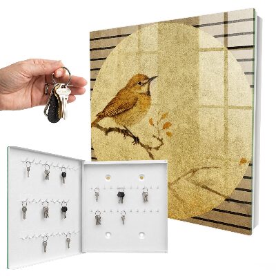 Armario para llaves de color crema con diseño de pájaro