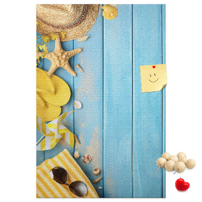 Decoración pizarra de corcho Accesorios de verano sobre un fondo de madera azul.