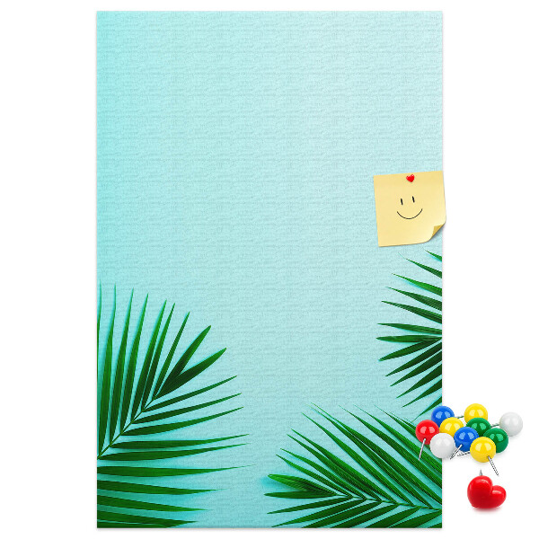 Tablero de corcho para pared Hojas tropicales sobre un fondo azul