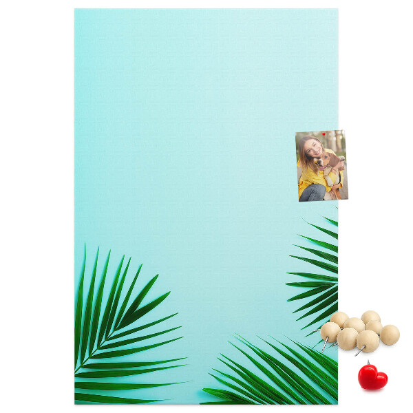 Tablero de corcho para pared Hojas tropicales sobre un fondo azul