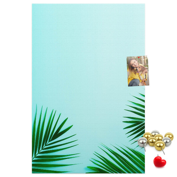 Tablero de corcho para pared Hojas tropicales sobre un fondo azul