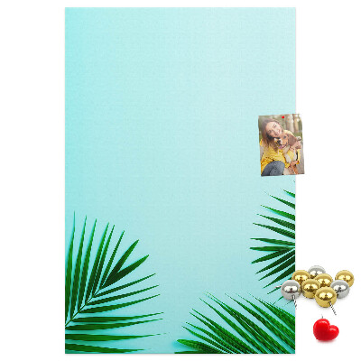 Tablero de corcho para pared Hojas tropicales sobre un fondo azul