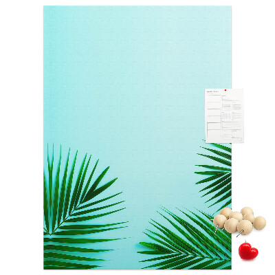 Tablero de corcho para pared Hojas tropicales sobre un fondo azul