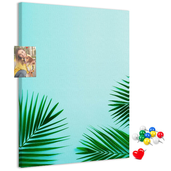 Tablero de corcho para pared Hojas tropicales sobre un fondo azul