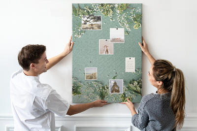 Pizarra de corcho decorativa fondo verde con flores y hojas delicadas