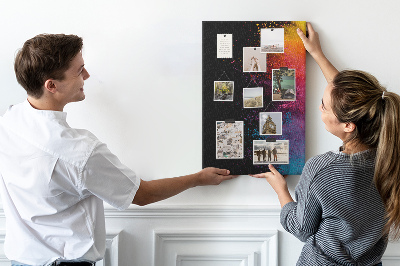 Pizarra de corcho decorativa con diseño de explosiones coloridas sobre fondo negro