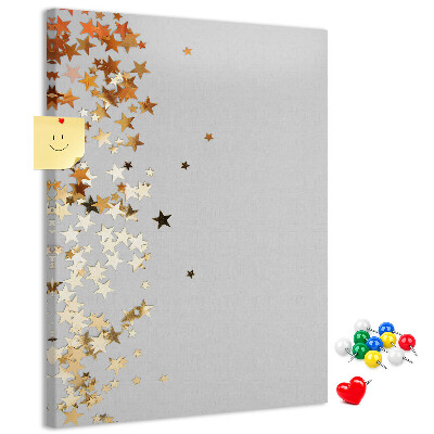 Tablón de corcho Estrellas doradas y plateadas sobre fondo gris.
