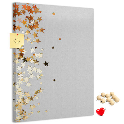 Tablón de corcho Estrellas doradas y plateadas sobre fondo gris.
