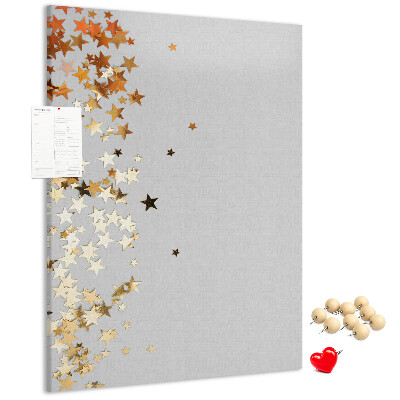 Tablón de corcho Estrellas doradas y plateadas sobre fondo gris.