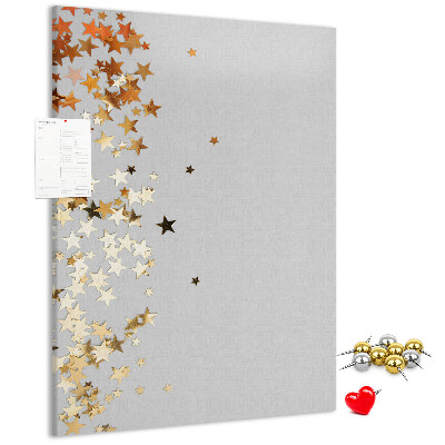 Tablón de corcho Estrellas doradas y plateadas sobre fondo gris.