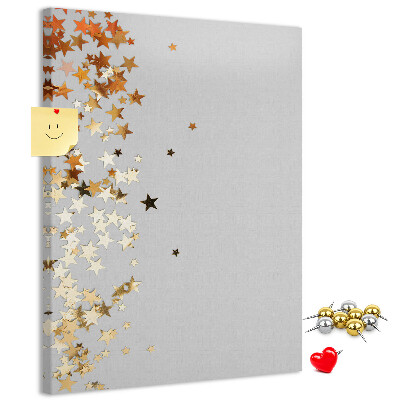 Tablón de corcho Estrellas doradas y plateadas sobre fondo gris.