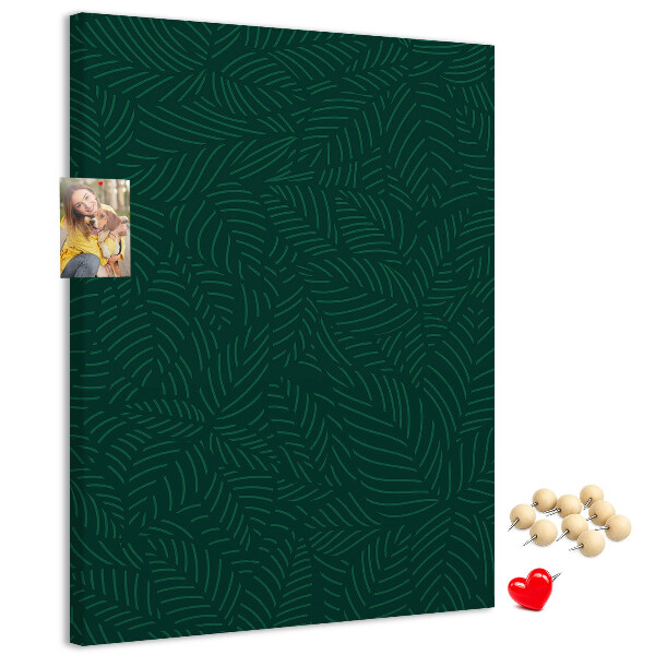Pizarra de corcho decorativa con diseño de hojas sobre fondo verde oscuro