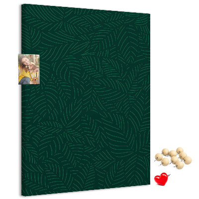 Pizarra de corcho decorativa con diseño de hojas sobre fondo verde oscuro