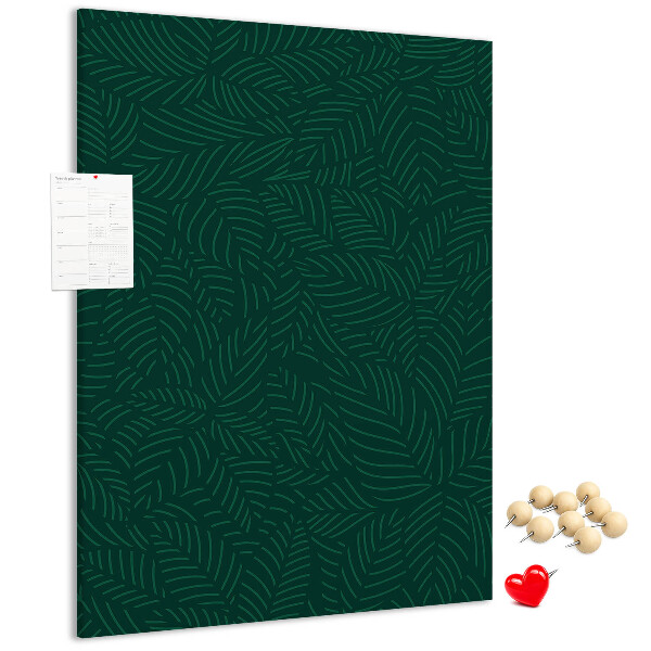 Pizarra de corcho decorativa con diseño de hojas sobre fondo verde oscuro