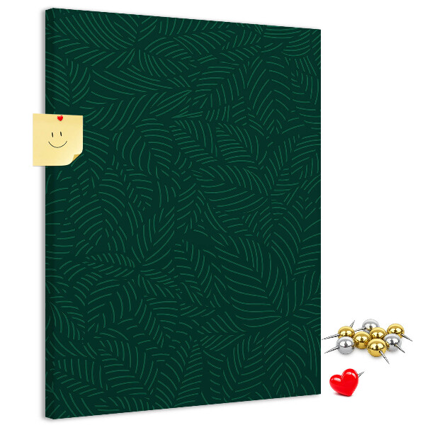 Pizarra de corcho decorativa con diseño de hojas sobre fondo verde oscuro