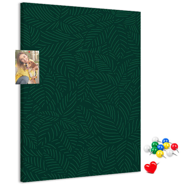 Pizarra de corcho decorativa con diseño de hojas sobre fondo verde oscuro