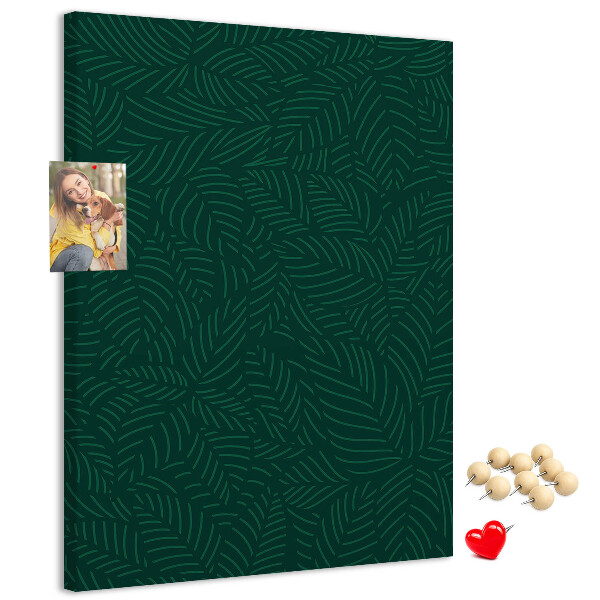 Pizarra de corcho decorativa con diseño de hojas sobre fondo verde oscuro