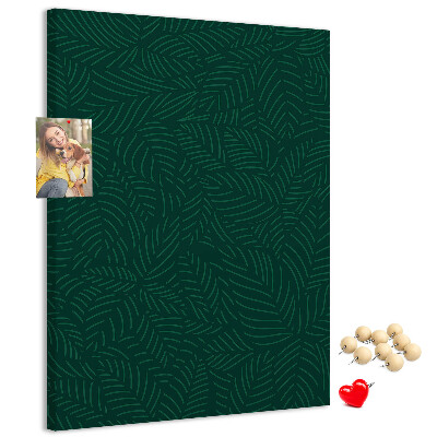 Pizarra de corcho decorativa con diseño de hojas sobre fondo verde oscuro