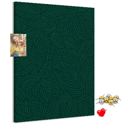 Pizarra de corcho decorativa con diseño de hojas sobre fondo verde oscuro