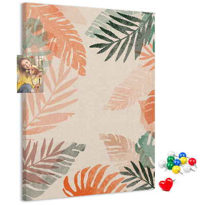 Pizarra de corcho decorativa con diseño de hojas tropicales en tonos suaves
