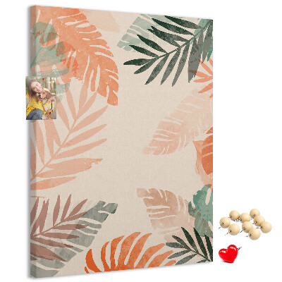 Pizarra de corcho decorativa con diseño de hojas tropicales en tonos suaves