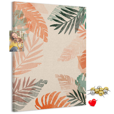 Pizarra de corcho decorativa con diseño de hojas tropicales en tonos suaves
