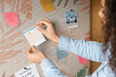 Pizarra de corcho decorativa con diseño de hojas tropicales en tonos suaves
