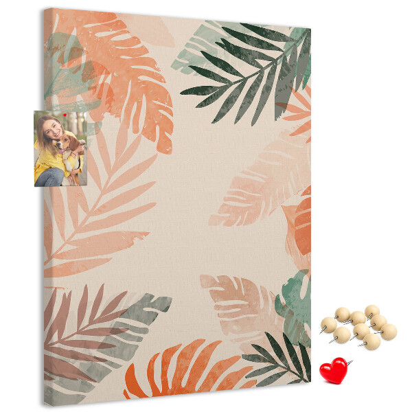 Pizarra de corcho decorativa con diseño de hojas tropicales en tonos suaves
