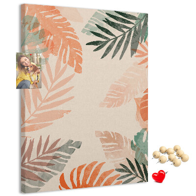 Pizarra de corcho decorativa con diseño de hojas tropicales en tonos suaves