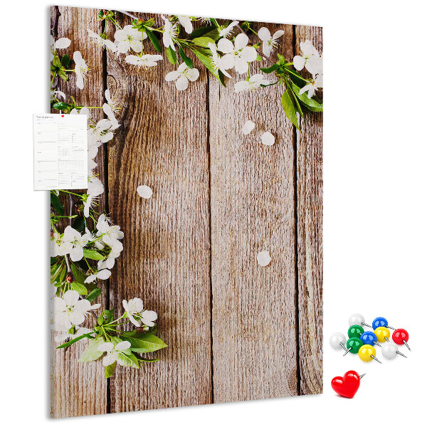 Tablero de corcho con diseño de flores sobre fondo de madera