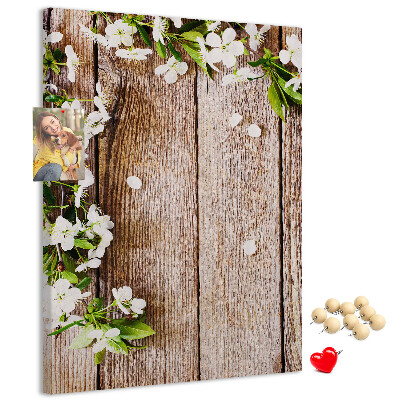 Tablero de corcho con diseño de flores sobre fondo de madera