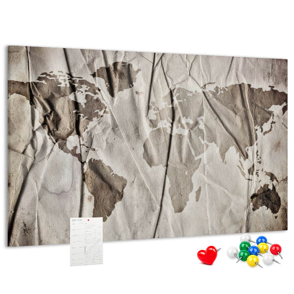 Tablero de corcho decorado Un mapamundi dañado sobre un fondo de papel.