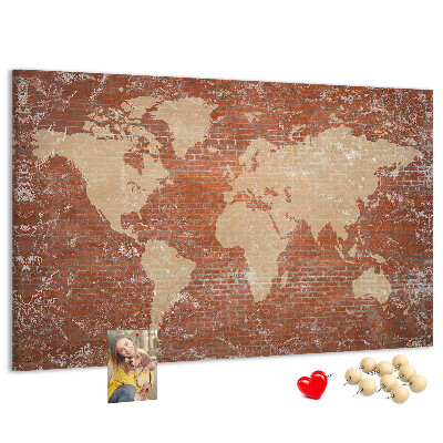 Tablero de corcho decorado Un mapamundi contra una pared de ladrillos