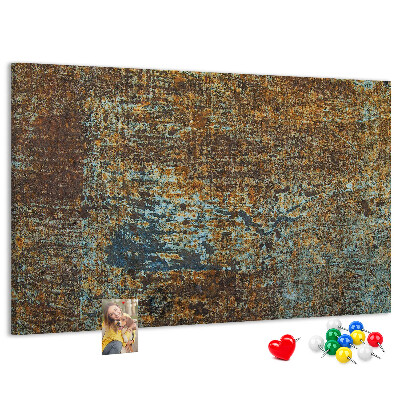 Pizarra de corcho Superficie oxidada con detalles azules.
