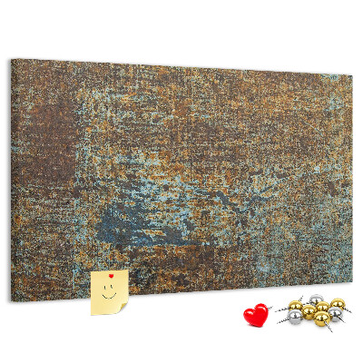 Pizarra de corcho Superficie oxidada con detalles azules.