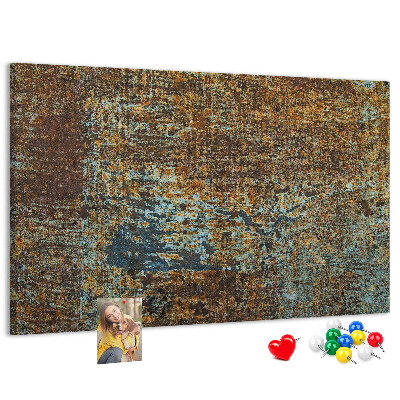 Pizarra de corcho Superficie oxidada con detalles azules.