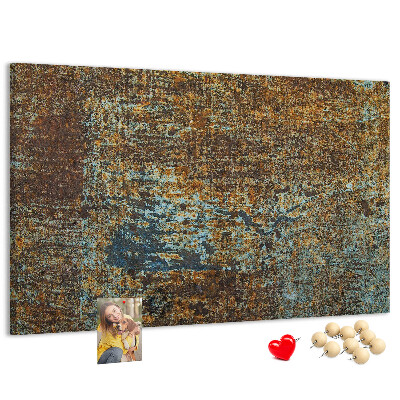 Pizarra de corcho Superficie oxidada con detalles azules.
