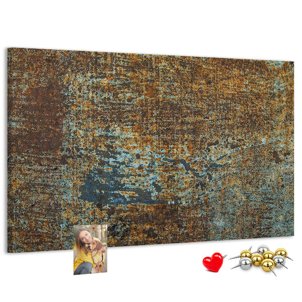 Pizarra de corcho Superficie oxidada con detalles azules.