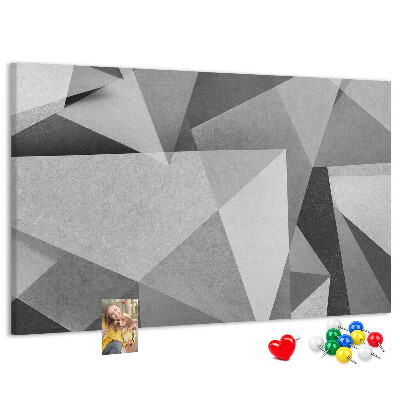 Pizarra de corcho con diseño de formas geométricas abstractas grises y negras