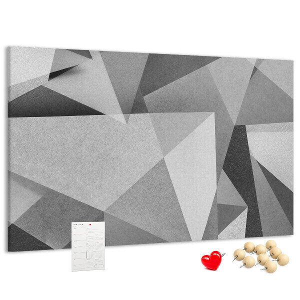 Pizarra de corcho con diseño de formas geométricas abstractas grises y negras