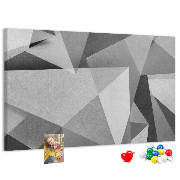 Pizarra de corcho con diseño de formas geométricas abstractas grises y negras