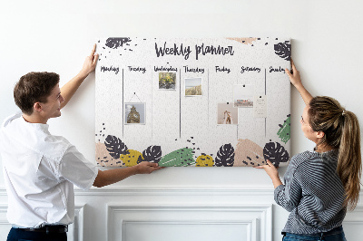 Pizarra de corcho con diseño de hojas tropicales para planificación semanal