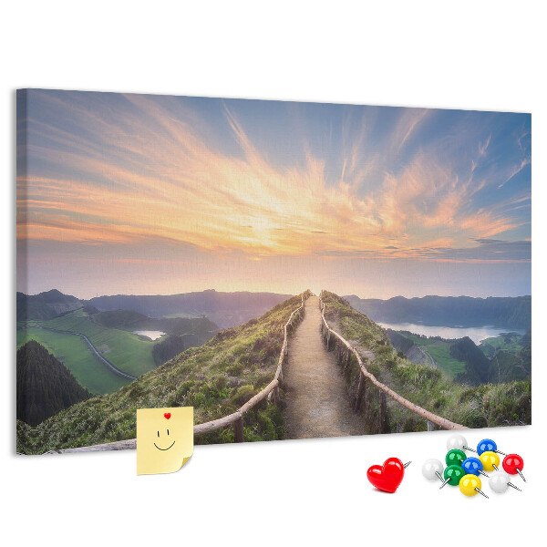 Tablero de corcho decorado con diseño de un sendero pintoresco en las montañas al atardecer