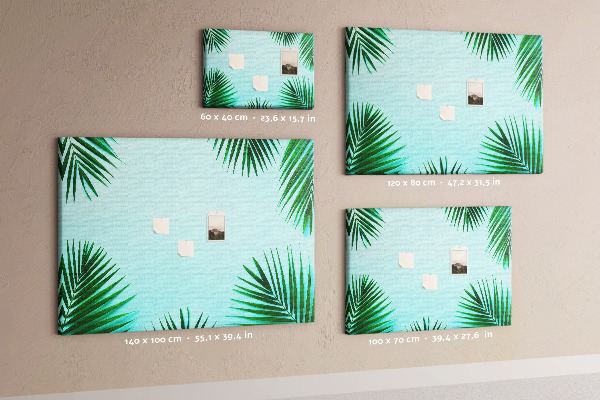 Pizarra de corcho con diseño de hojas tropicales sobre fondo azul