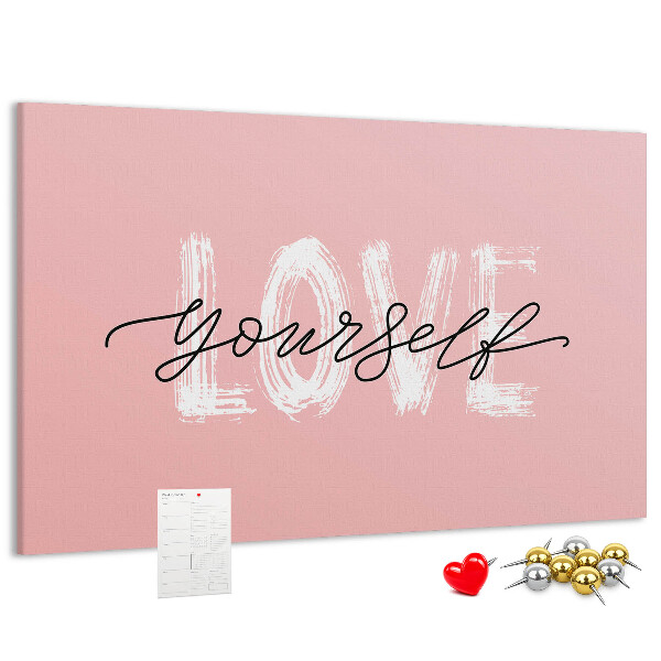 Tablero de corcho decorado Amor propio sobre un fondo rosa