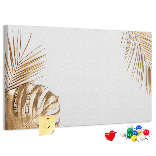 Pizarra de corcho con diseño de hojas doradas sobre fondo blanco